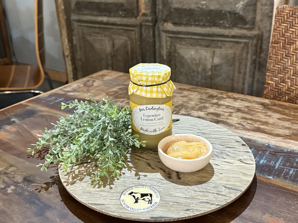 close up of lemon curd in a glas jar at Hunter Valley Cheese, rich golden colour with smooth creamy texture, artisan preserve sourced from our English friends