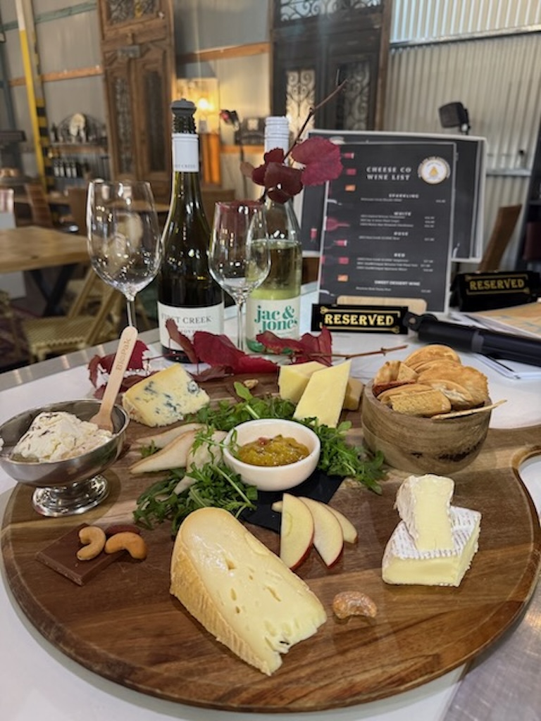 Artisan cheeseboard wto share featuring handcrafted Hunter Valley Cheeses, fresh fruit, crackers, local accompaniments and option wine pairings served in the Hunter Valley Cheese tasting room.